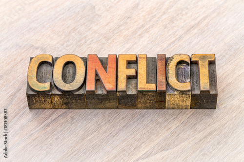 conflict word abstract in wood type