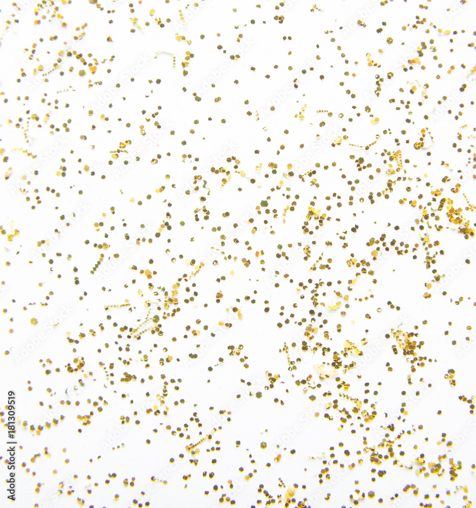 Scattered golden sparkles on white background. Festive backdrop.