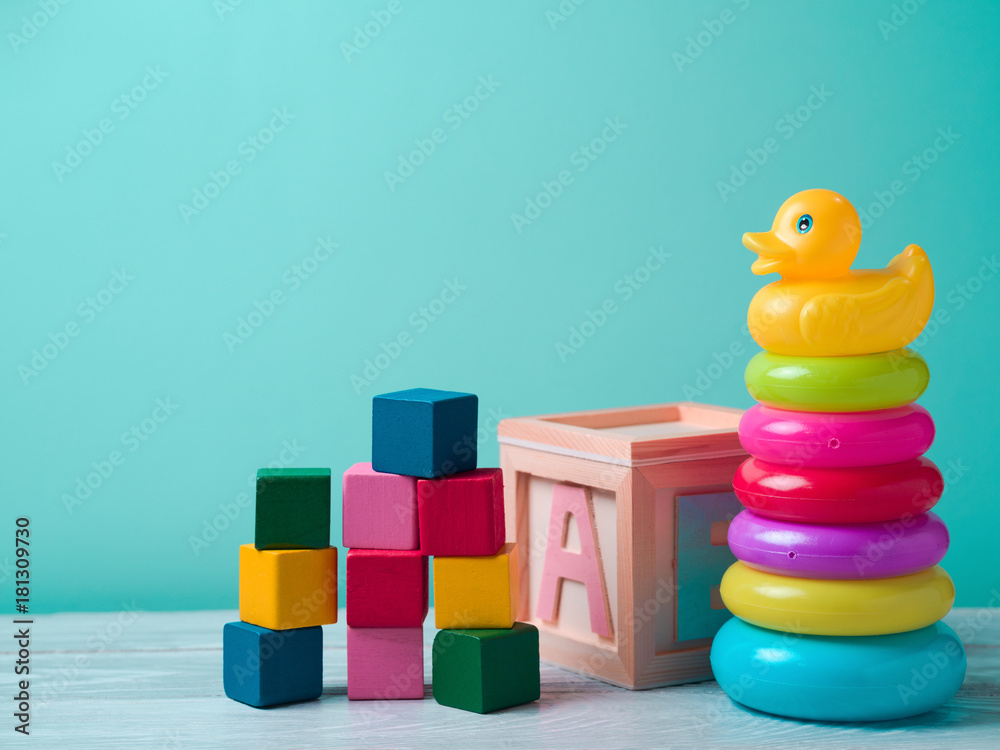 Baby toys on wooden table - obrazy, fototapety, plakaty 