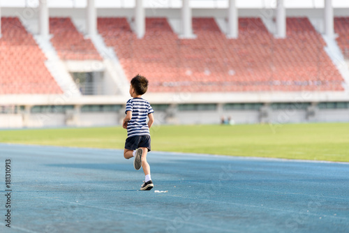 Boy running on the blue track