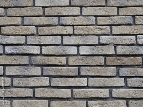 Brick wall with large gaps for cement. Unusual brick laying. Good background with an interesting smooth surface.