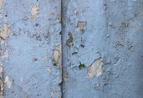 Blue peeling paint. Old concrete background. Faded walls. Abstract textures.