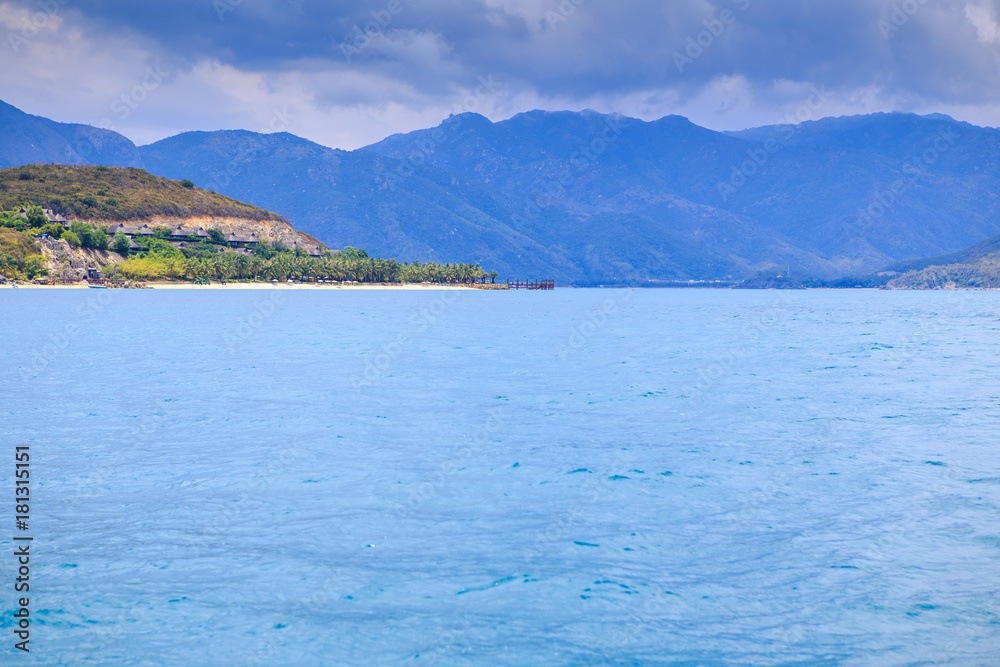 Clouds Lace in Blue Sky above Azure Sea Hill