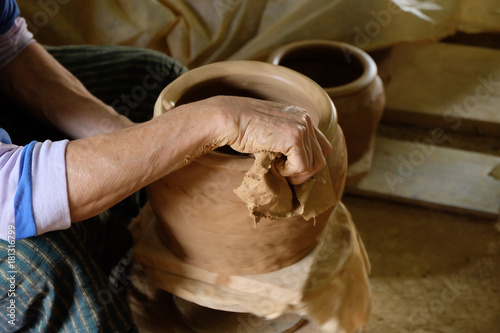 Close up hands working on pottery wheel