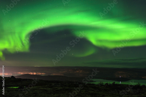 Aurora in the night sky hills  and tundra.