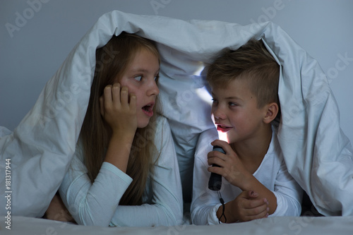 Slika na platnu children tell each other terrible stories for the night under the blanket