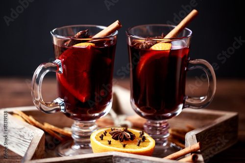 Christmas hot mulled wine in a glass with spices and citrus fruit. Mulled wine with cinnamon, anise and orange