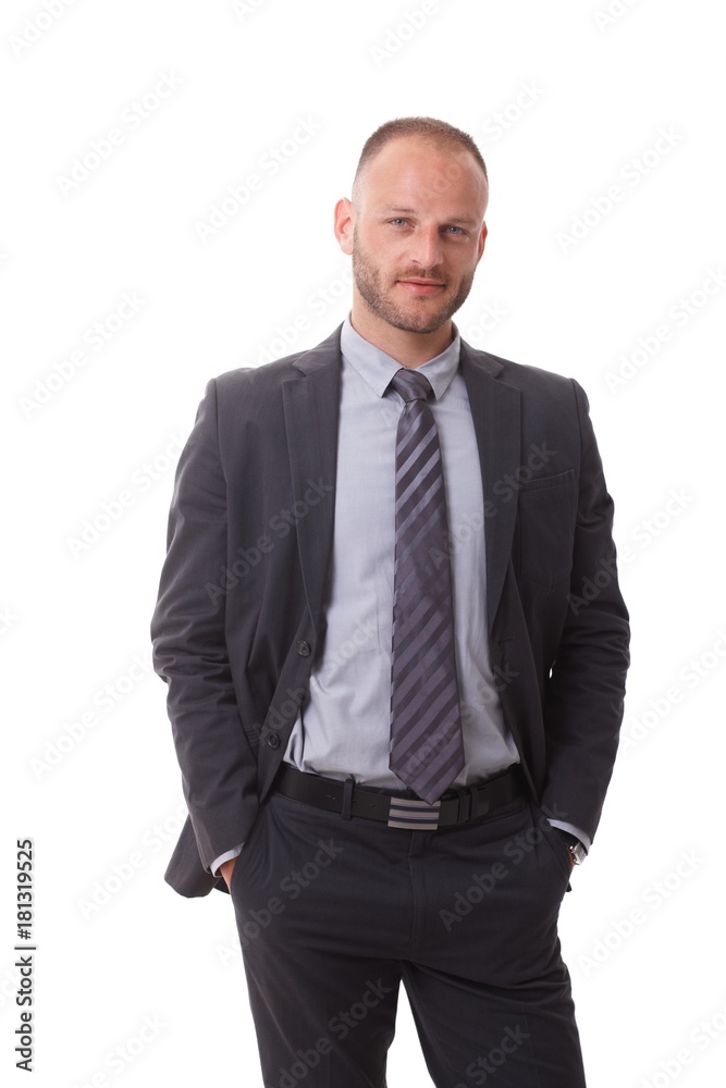 Confident businessman standing hands in pockets Confident businessman standing hands in pockets