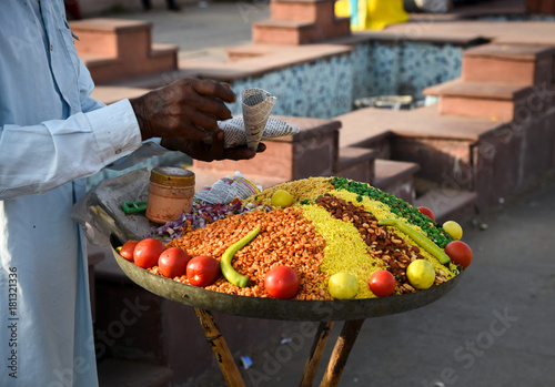 Man selling spices and vegetables.