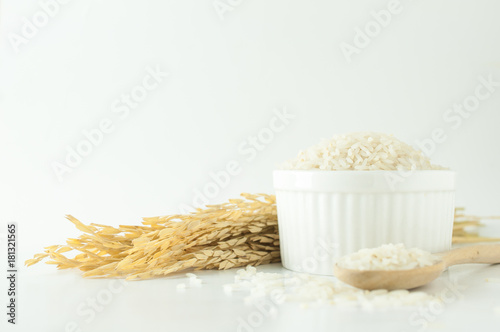 Close up rice in white bowl with wheat on isolated white background