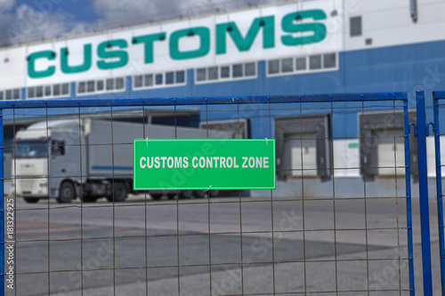 Customs control space with truck near warehouse storage of goods.