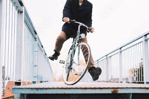 Close up of hipster man riding bicycle