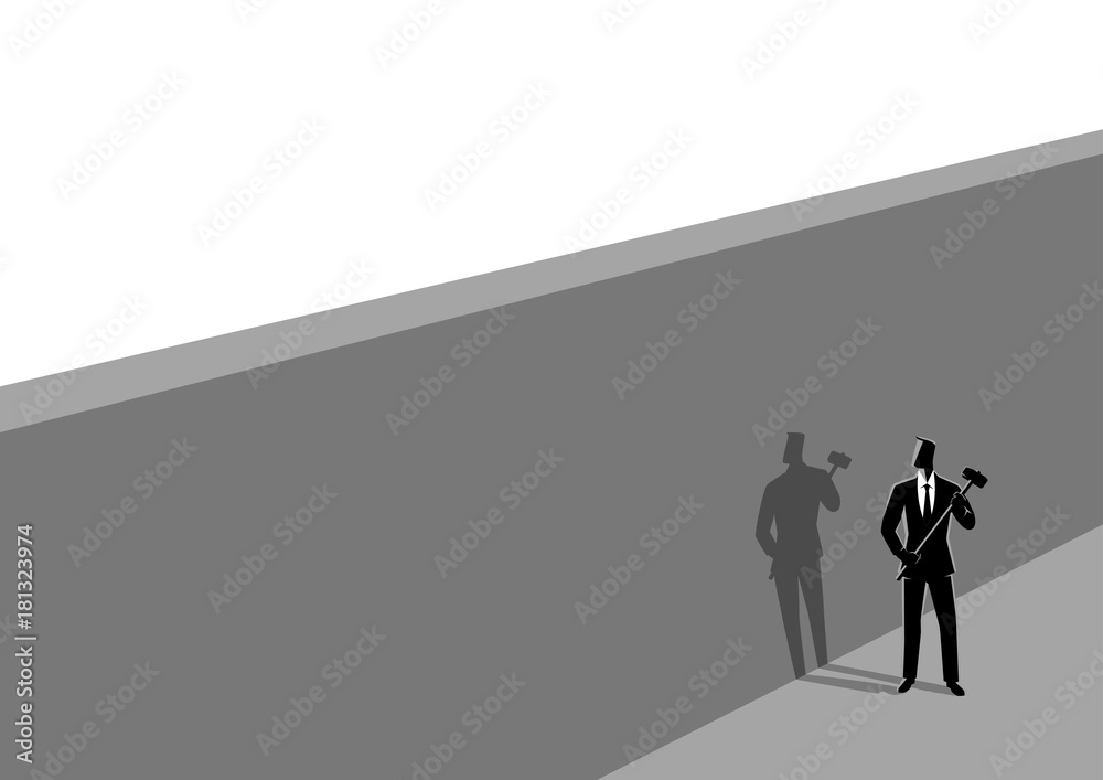 Businessman standing near wall with a hammer