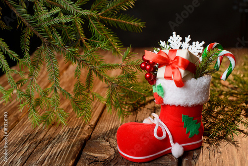 The boots of Santa Claus with decorations on a wooden table