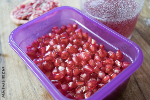 pomegranate seeds in a colored plastic tray