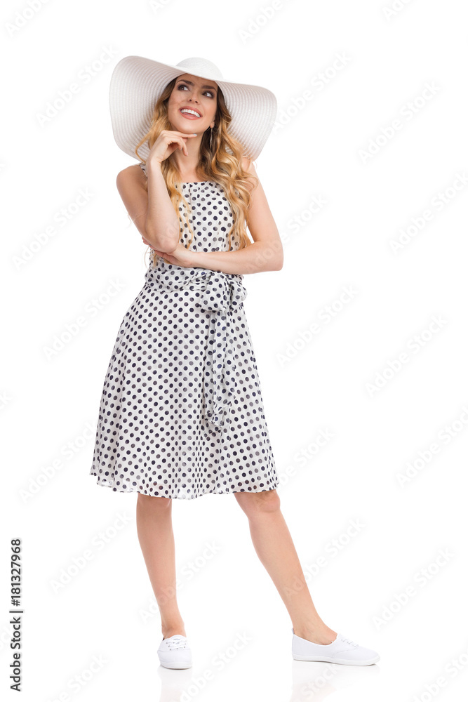 Young Woman In Summer Dress And Sun Hat Is Looking Up And Thinking Young Woman In Summer Dress And Sun Hat Is Looking Up And Thinking