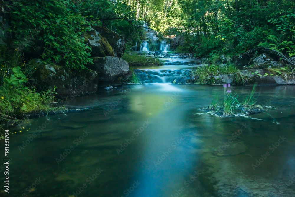 A beautiful river with small watefalls and bridge A beautiful river with small watefalls and bridge
