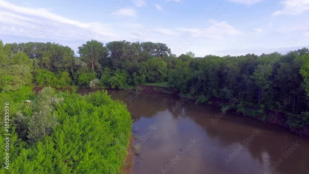 AERIAL: The nature landscape at dawn. A small river in a dense forest. Summer is in full swing. Beautiful soft light of morning sun. AERIAL: The nature landscape at dawn. A small river in a dense forest. Summer is in full swing. Beautiful soft light of morning sun.