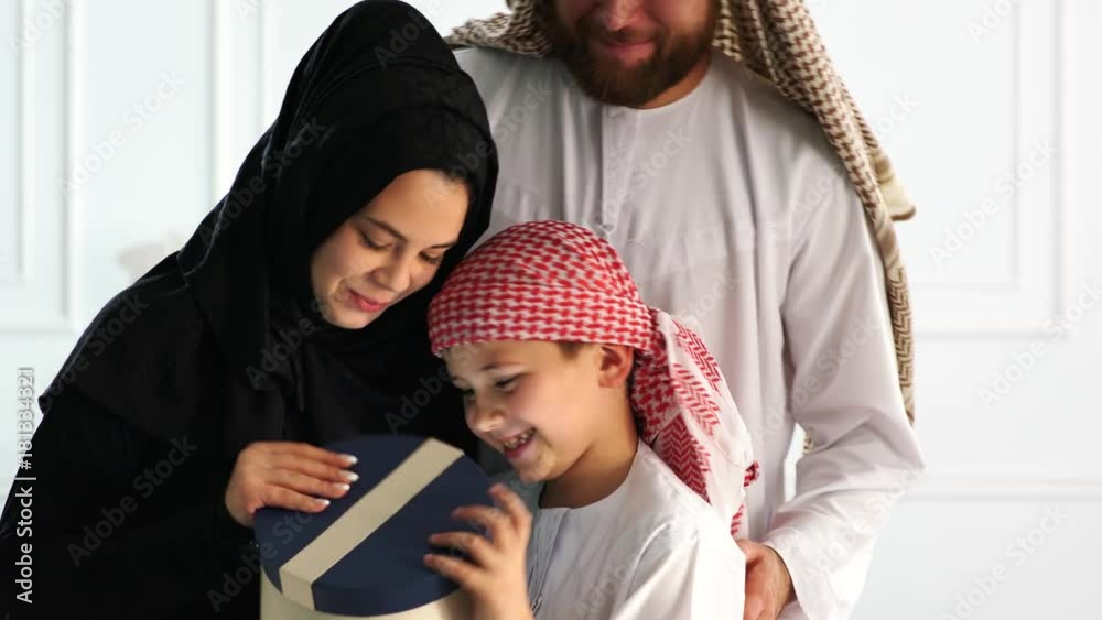 Arabic Muslim family with gift box.Middle eastern family. Arabic Muslim family with gift box.Middle eastern family.