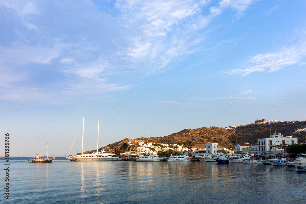 Warm dawn colors over the harbor of Patmos island, Dodecanese, Greece 
