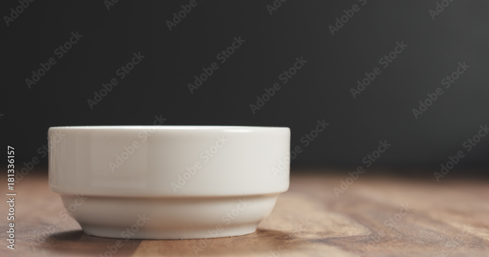 closeup of white bowl on wood table