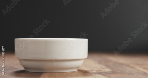 Fototapeta Naklejka Na Ścianę i Meble -  closeup of white bowl on wood table