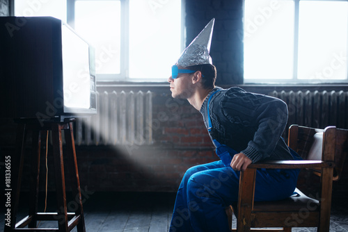 Man in tinfoil helmet and glasses, UFO phobia