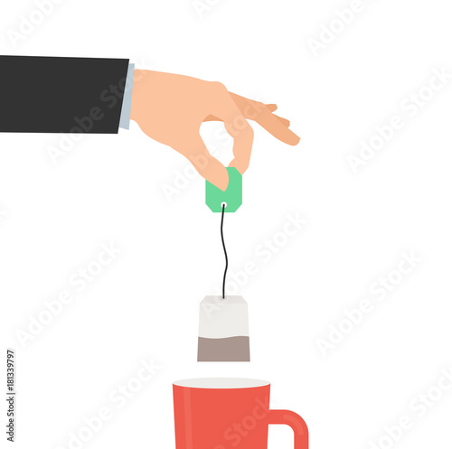 human hand holding tea bag and cup on white background
