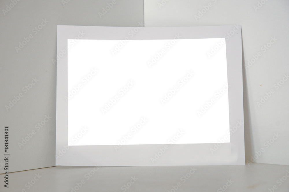 Photo paper frame standing on white building corner Photo paper frame standing on white building corner