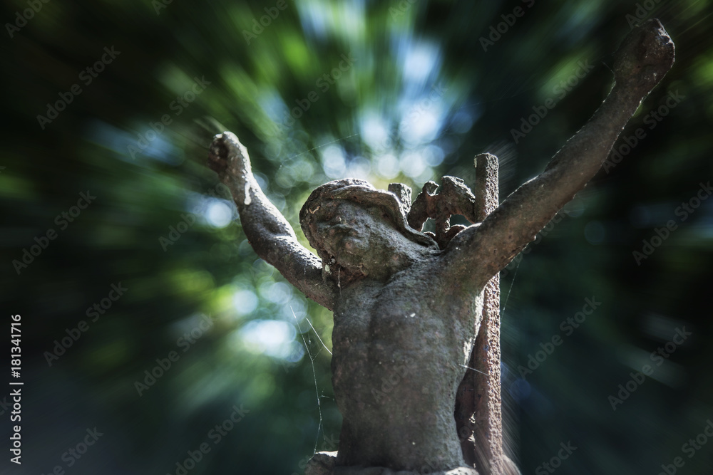 Partially destroyed ancient statue of the crucifixion of Jesus Christ (Faith, religion, suffering, love, God concept)