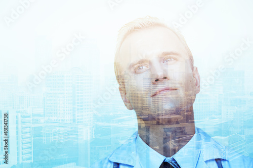 portrait of handsome and smart doctor with action posture and city image double exposure