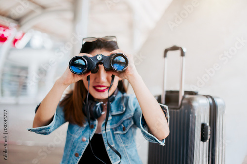 travel asian girl hold binocular with background of city downtown travel concept