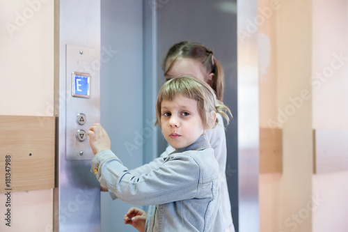 little girls causing   elevator in   high-rise building