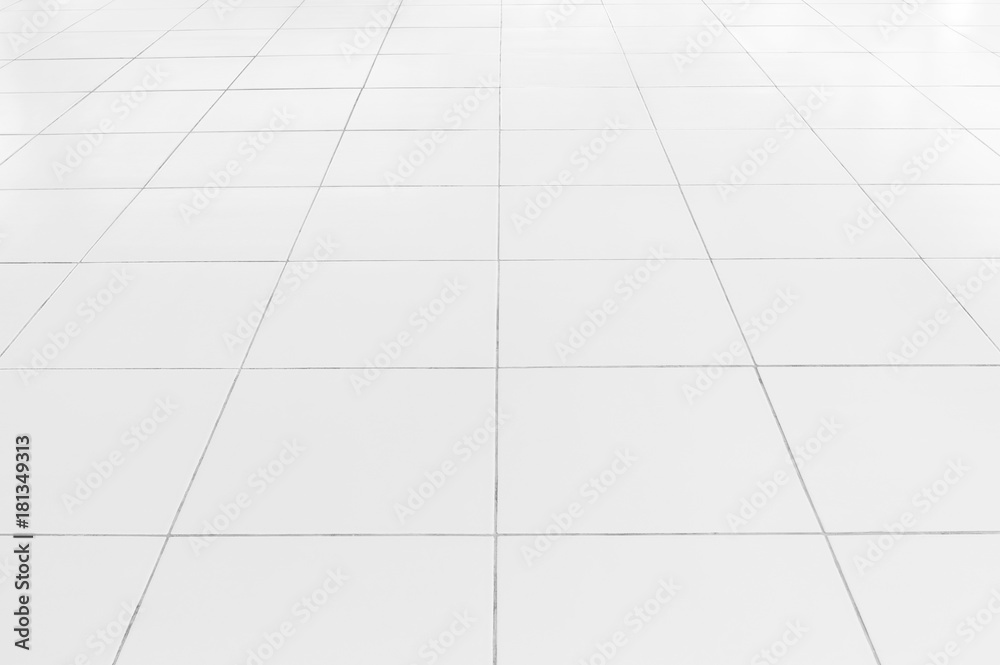White tile floor background in perspective view. Clean, shiny, symmetry with grid line texture. For decoration in bathroom, kitchen and laundry room. And empty or copy space for product display also. White tile floor background in perspective view. Clean, shiny, symmetry with grid line texture. For decoration in bathroom, kitchen and laundry room. And empty or copy space for product display also.