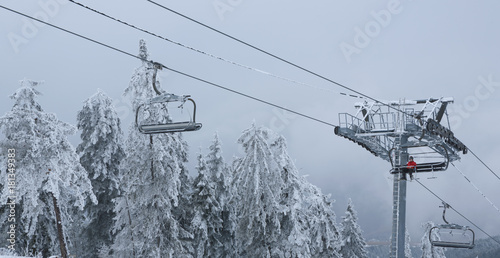 winter mountain landscape with with modern ski lift chair.