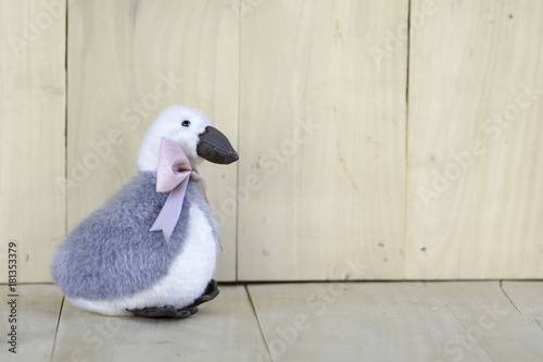 Goose Doll Tie Bow Pink on wooden floor.