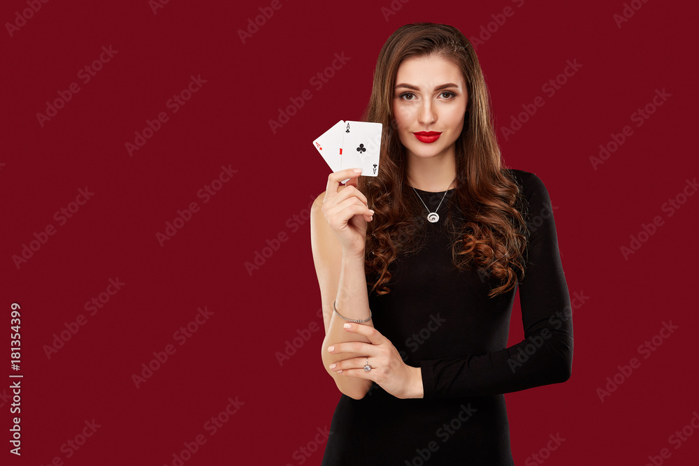 Naklejka premium Beautiful caucasian woman in black dress with poker cards gambling in casino