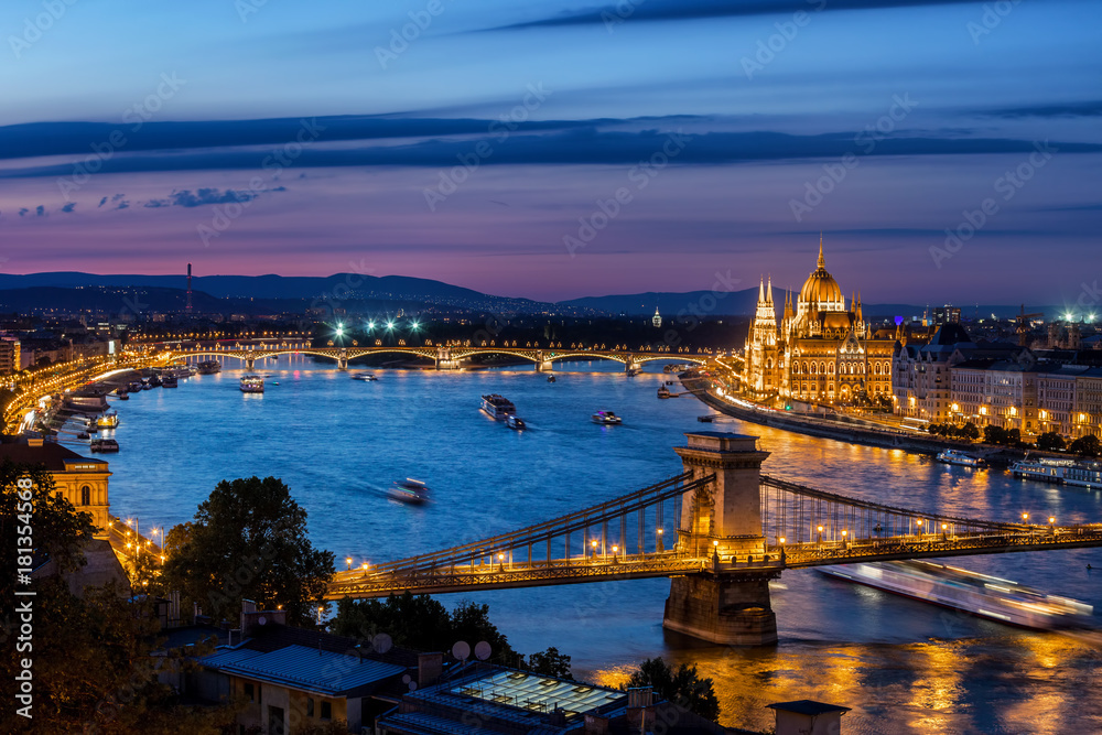 City of Budapest at dusk in Hungary, blue hour cityscape with lighted Chain Bridge and Hungarian Parliament at Danube River