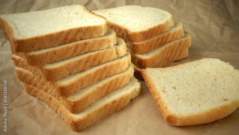 Dry slices of white bread in paper. Sliced toast in paper Dry slices of white bread in paper. Sliced toast in paper