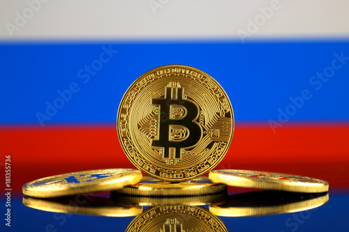 Physical version of Bitcoin (new virtual money) and Russia Flag. Conceptual image for investors in cryptocurrency and Blockchain Technology in Russia.