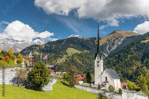 the Swiss alpine village of Seewis with its prominent church in summer in the Swiss Alps photo