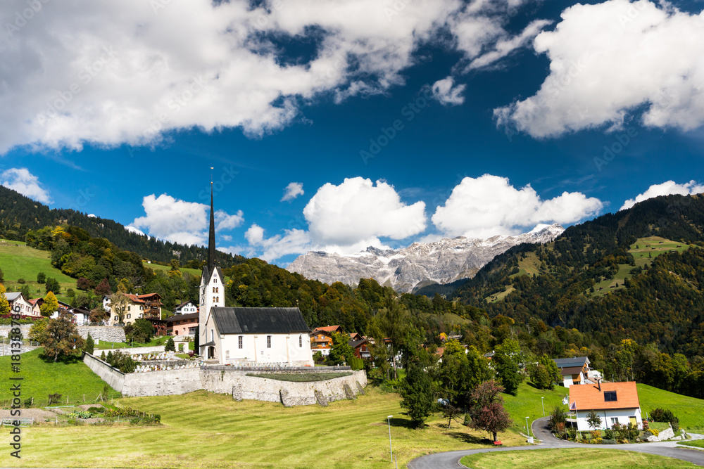 the Swiss alpine village of Seewis with its prominent church in summer in the Swiss Alps