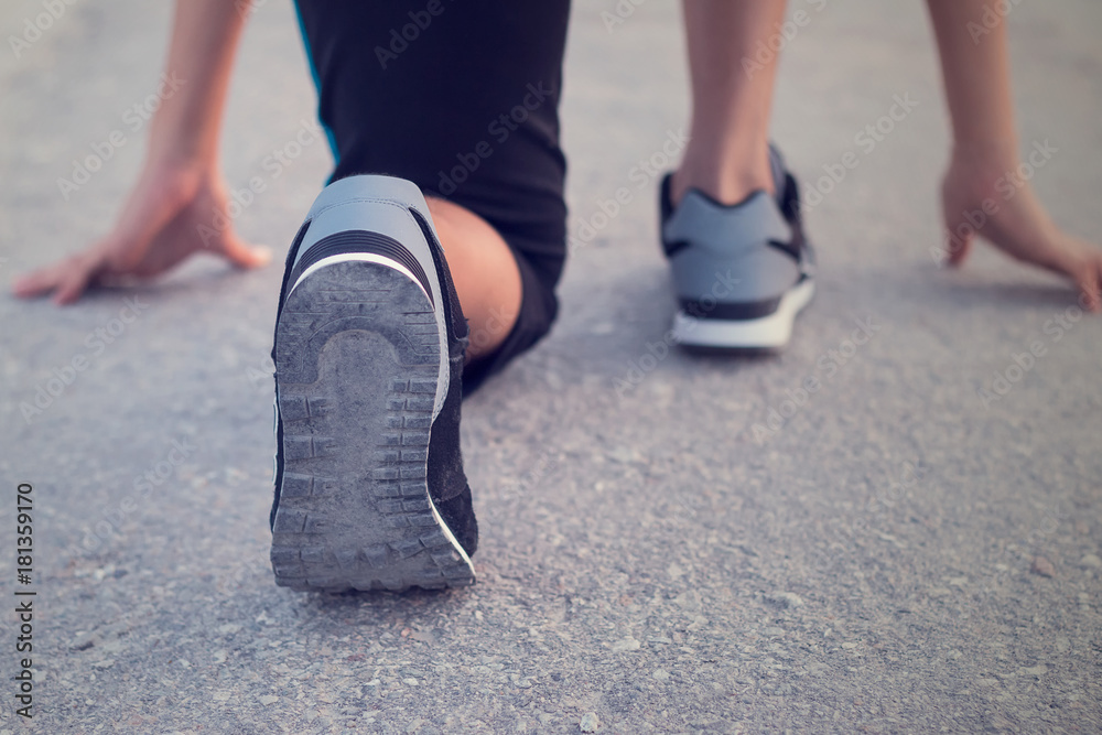 Young woman on start running position. Healthy concept.