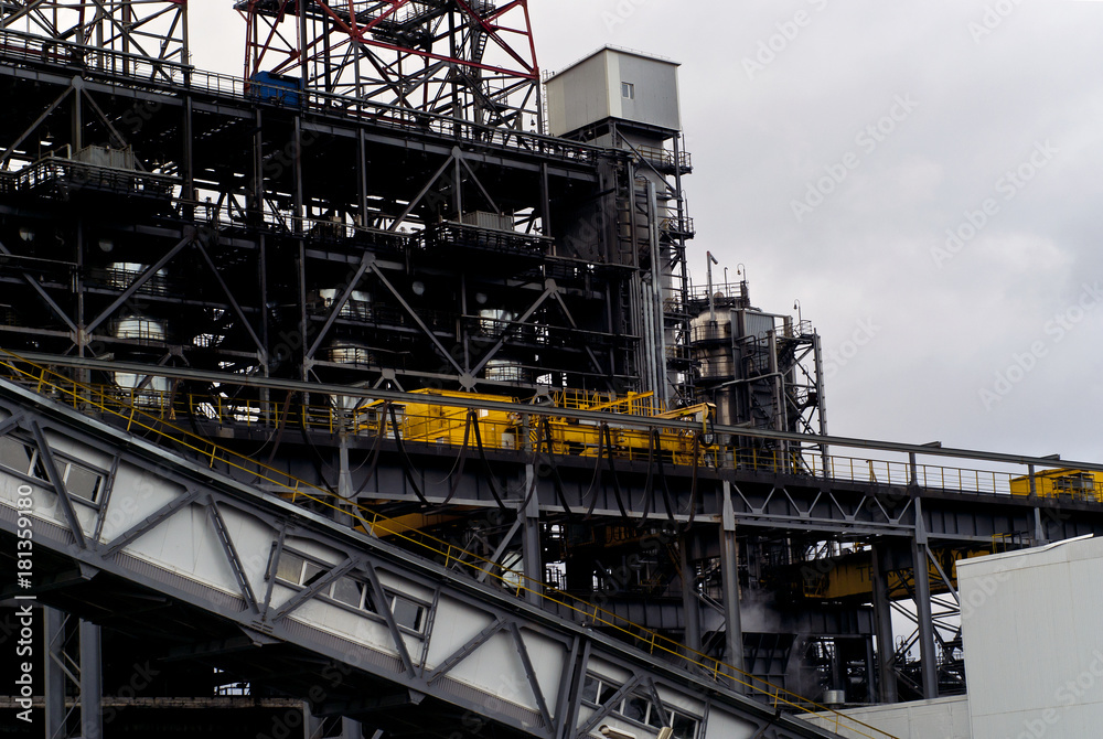industrial background: a fragment of some industrial structure with rack-beam structures, steel tanks and inclined covered belt conveyor industrial background: a fragment of some industrial structure with rack-beam structures, steel tanks and inclined covered belt conveyor