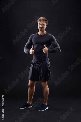 Male model in active sportswear against black background with copy space © nazarovsergey