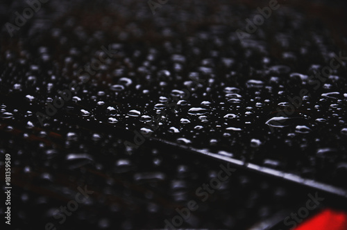 Droplets on the black roof of the car detail