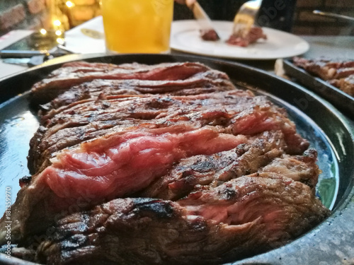 Medium soft chewey Wagyu rump steak served on hot plate photo