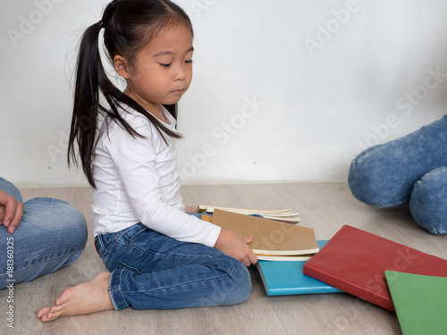 Asian Schoolgirl holding book at home for ready to go to school.Back to school concept. photo