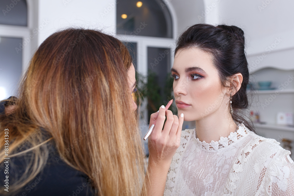 makeup artist applying lip contour with pencil makeup artist applying lip contour with pencil