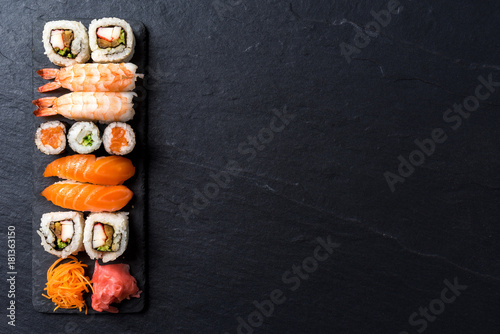 Overhead shot of Japanese sushi on black concrete background